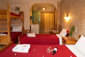 a bedroom with two beds and a bunk bed at G&P Rooms Matala in Matala