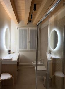 a bathroom with a shower and a sink and a toilet at Agriturismo Rive De Guia in Valdobbiadene +28 photos