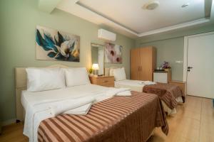 a hotel room with two beds in a room at Hotel Dost in Marmaris