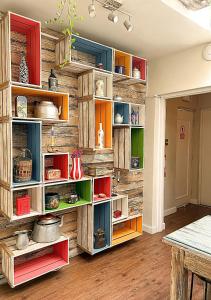 a room with wooden walls and shelves with various items at Wakapunku Boutique B&B in Cusco