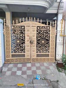 a gate to a house with an ornate door at Uma's Homestay in Gwalior