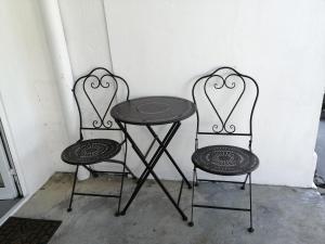 a table and two chairs with a table and two hearts at Casa do Roberto in Lajes das Flores +10 photos
