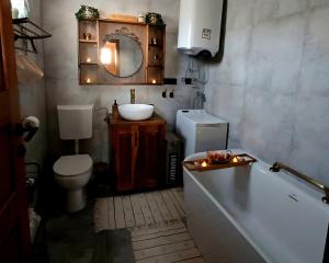 a bathroom with a tub and a toilet and a sink at Lorraine's cabin Plitvice in Drežnik Grad +34 photos