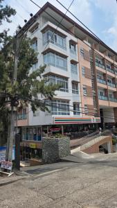 a large apartment building in front of a street at The Highland Condotel in Baguio