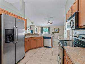 a large kitchen with a stainless steel refrigerator at Ocala Oasis 3 bedroom in Ocala