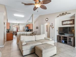 a living room with a couch and a flat screen tv at Ocala Oasis 3 bedroom in Ocala