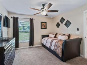 a bedroom with a bed and a ceiling fan at Ocala Oasis 3 bedroom in Ocala