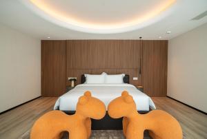 a hotel room with a bed with two deer heads at Leston Hotel in Bangkok +26 photos