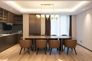 a kitchen and dining room with a table and chairs at Leston Hotel in Bangkok