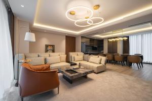 a living room with a couch and a table at Leston Hotel in Bangkok