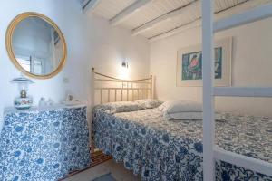 a bedroom with two beds and a mirror at Marousω's Μaisonette in Dhragoulás