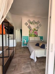 a bedroom with a bed with a mural on the wall at Villa Mbita Sardegna in Brunella +109 photos