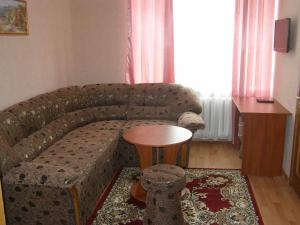 a living room with a couch and a table at ABBA Hotel in Kyiv