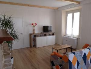 a living room with a couch and a tv in it at La Casita in Castelfidardo