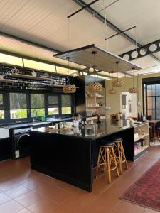 a kitchen with a large black island in a kitchen at Hartbeespoort Escape Hot Tub and Mountain Views in Skeerpoort