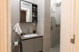a bathroom with a sink and a shower at Nova Apartments in Prizren +85 photos