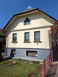 a white house with windows and a red fence at Privat DAŇO in Lisková