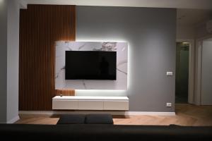 a living room with a tv on a wall at Villa Billa in Tirana