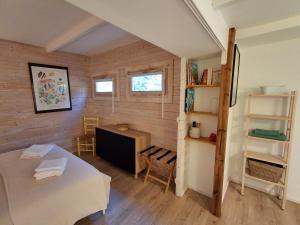 a room with a bed and a desk and a shelf at la bergerie des colles in Entrecasteaux +36 photos