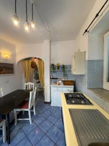 a kitchen with a table and a stove top oven at Casa vacanza maronti in Barano d'Ischia