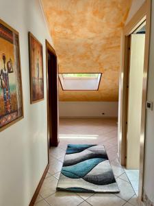 a hallway with a skylight and a rug on the floor at Orizzonte guest house in Laigueglia +12 photos