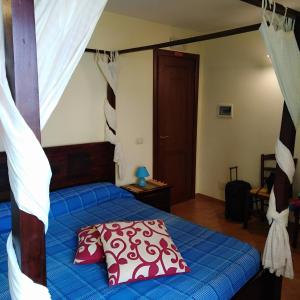 a bedroom with a bed with a blue comforter at Porta di Mare in Sciacca