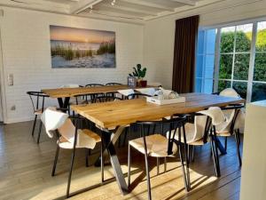a dining room with a wooden table and chairs at Luxury Villa in Sint-Idesbald with Jacuzzi in Sint-Idesbald