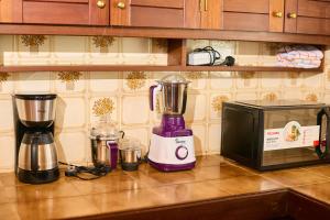a kitchen counter with a blender and a microwave at Cutie 3 br Villa Nyali in Mombasa