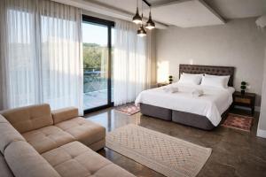 a bedroom with a bed and a couch at Villa Elite in Kuşadası
