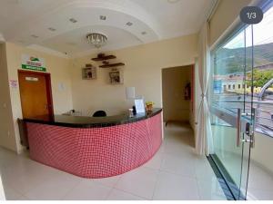 a lobby with a red counter in a building at Monte Santo palace hotel in Monte Santo