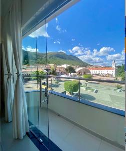 a room with a large window with a view at Monte Santo palace hotel in Monte Santo