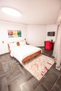 a bedroom with a bed and a rug at Hacienda in Saly Portudal