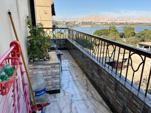 a balcony with a view of the water at Fatah apartment 12 in Luxor