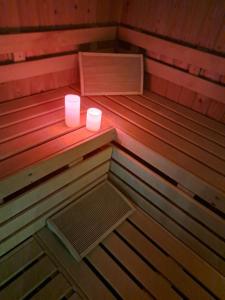 a small sauna with two candles in it at Suites et Wellness des Champs-Elysées in Ciney
