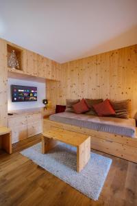 a bedroom with a bed with a wooden wall at La ferme des Colieuvres in Lièpvre