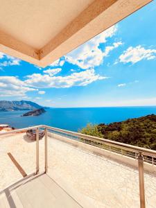 a view of the ocean from the balcony of a house at Hillside Apartment with Sea View in Budva