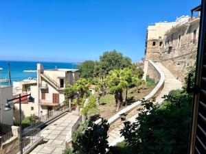 a view of a street with buildings and the ocean at Porta di Mare in Sciacca