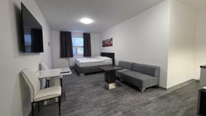 a living room with a couch and a bed at Apartmány Koruna in Ostrava