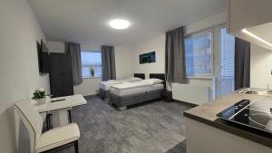 a room with two beds and a kitchen with a sink at Apartmány Koruna in Ostrava +21 photos