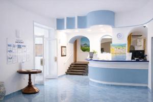 a lobby of a building with a blue counter at Av Isola Verde Hotel Thermal Spa in Ischia Town +66 photos