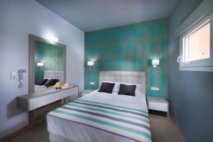 a bedroom with a large bed and a bathroom at Fresh Mare Apartments in Limenaria