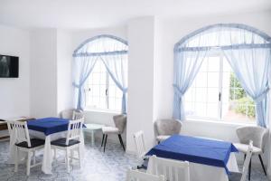 a room with two windows and a table and chairs at Av Isola Verde Hotel Thermal Spa in Ischia Town