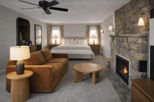 a living room with a bed and a couch and a fireplace at The Manchester View in Manchester