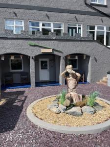a statue in front of a building at The Cove in Criccieth