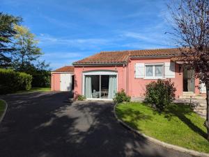a red house with a driveway at Gite De La Meronne in Vindelle