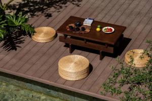 an overhead view of a wooden deck with a table andools at Aofeng Tangquan Secluded Villa in Jianchuan