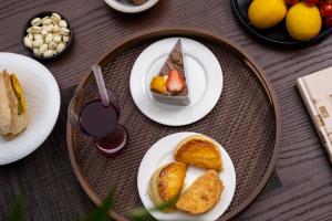 a table with plates of food and a drink at Aofeng Tangquan Secluded Villa in Jianchuan