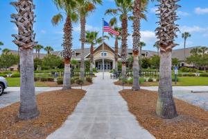 a sidewalk in front of a house with palm trees at MH3012: 3012 Marsh Haven in Seabrook Island