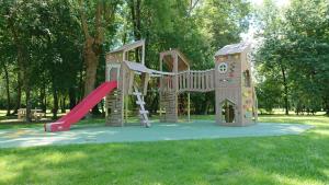 a playground with a slide in a park at Gite De La Meronne in Vindelle