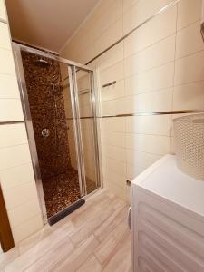 a shower with a glass door in a bathroom at Romantic Hillside Escape Sea View in Budva +14 photos